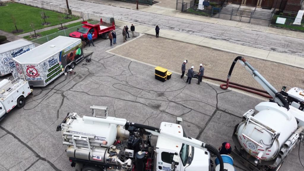 Aerial view of vacuum truck fleet servicing permeable pavement in Cleveland
